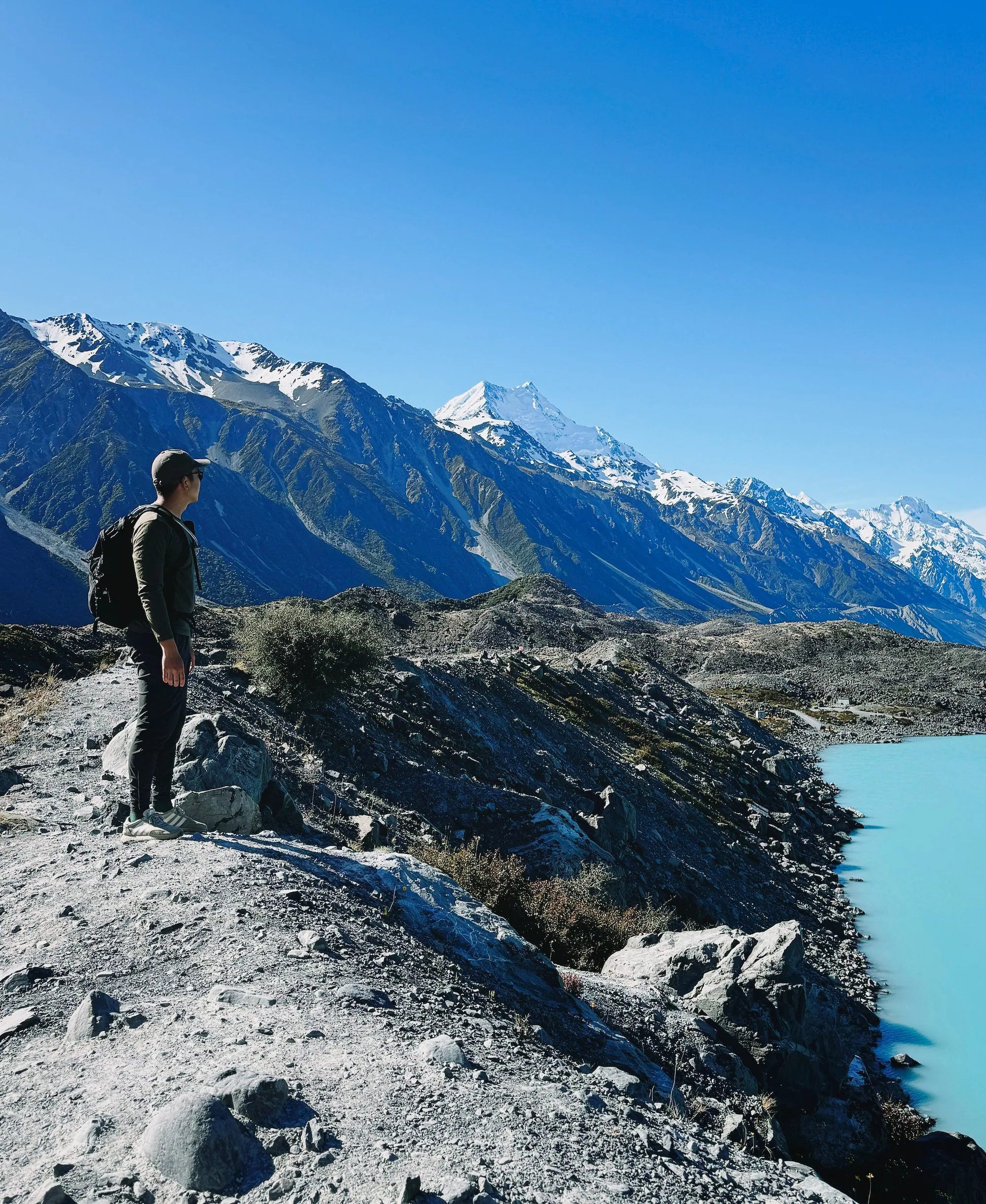 A hiker overlooking Tasman Glacier Lake and Aoraki
