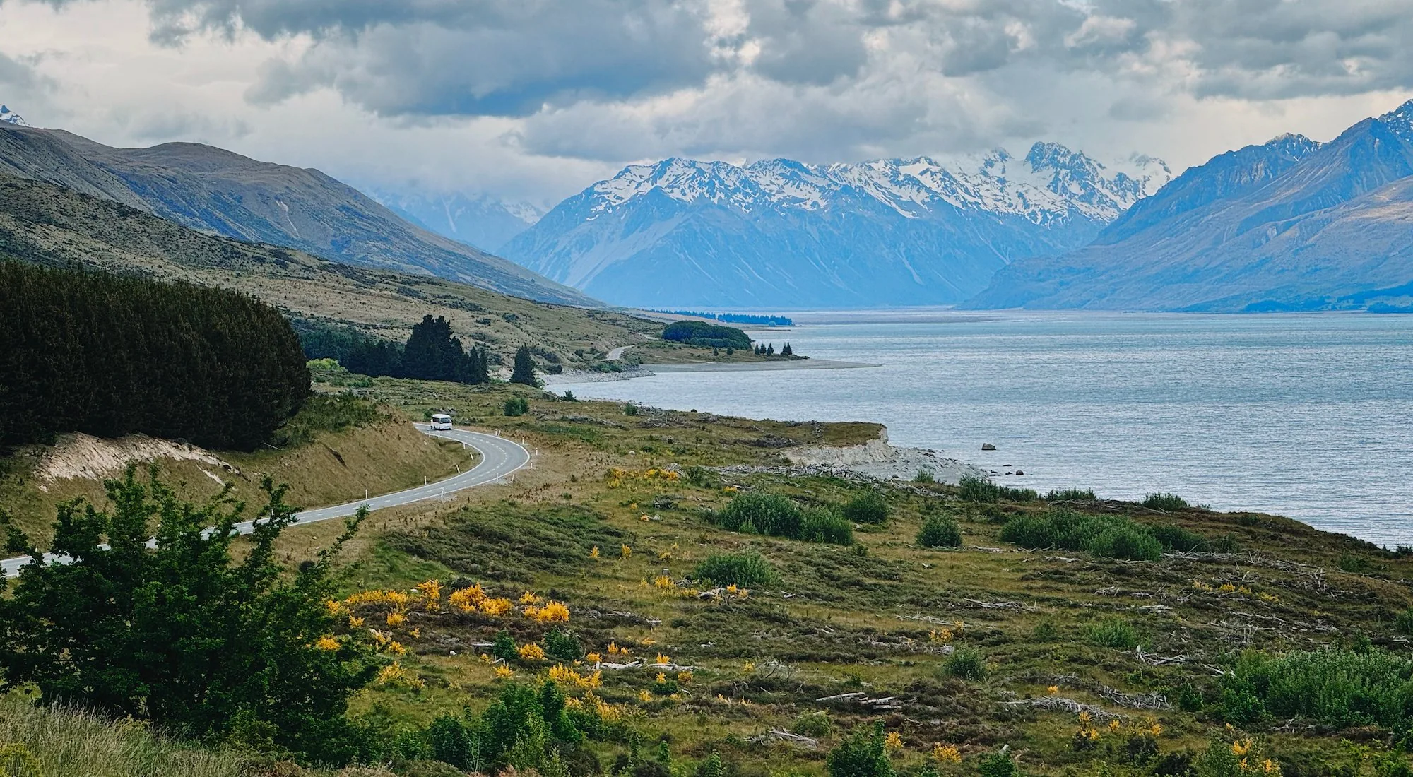 The road curving along Lake Pukaki toward the Southern Alps