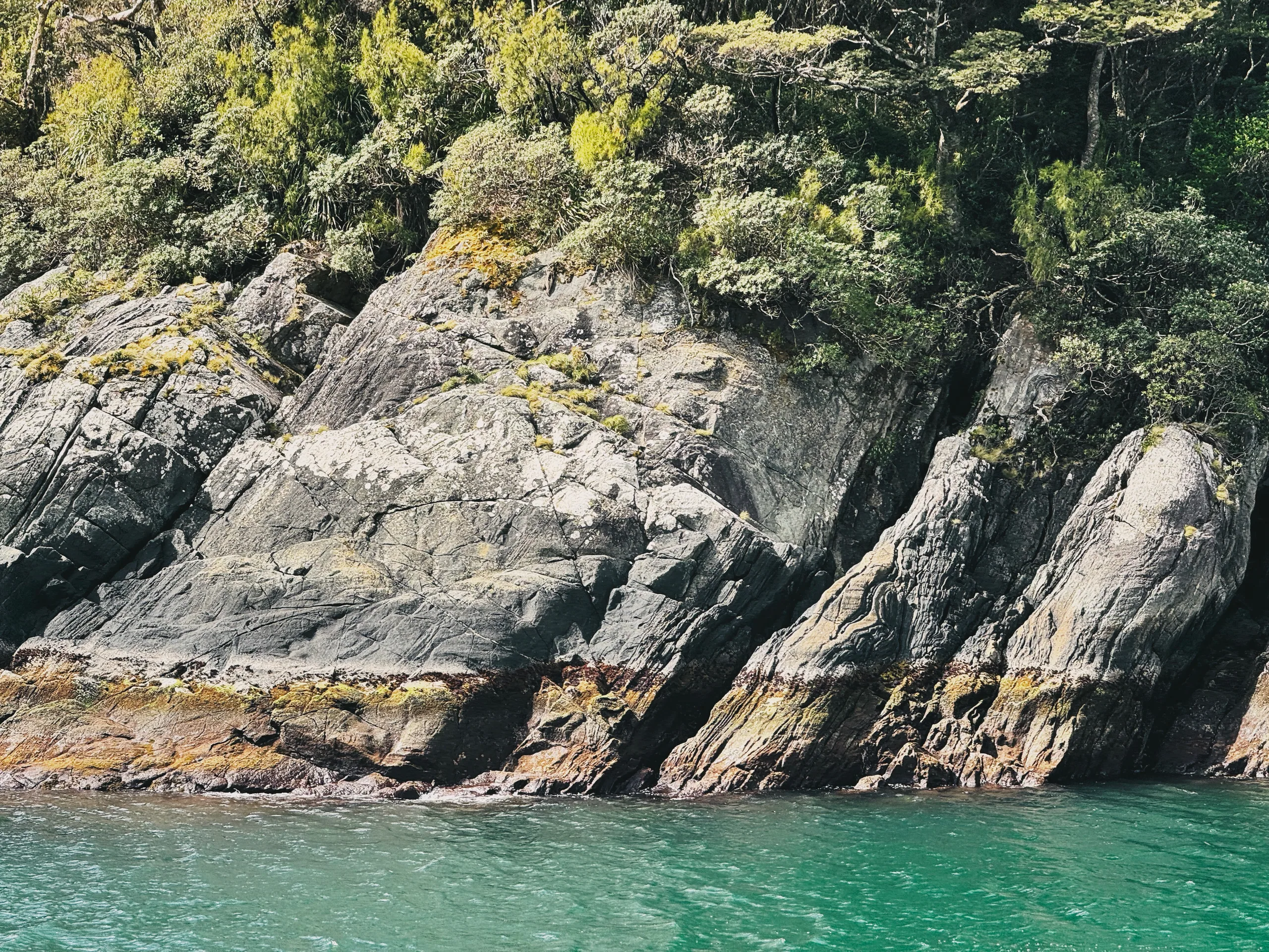 Dark overlapping mountain faces along Milford Sound