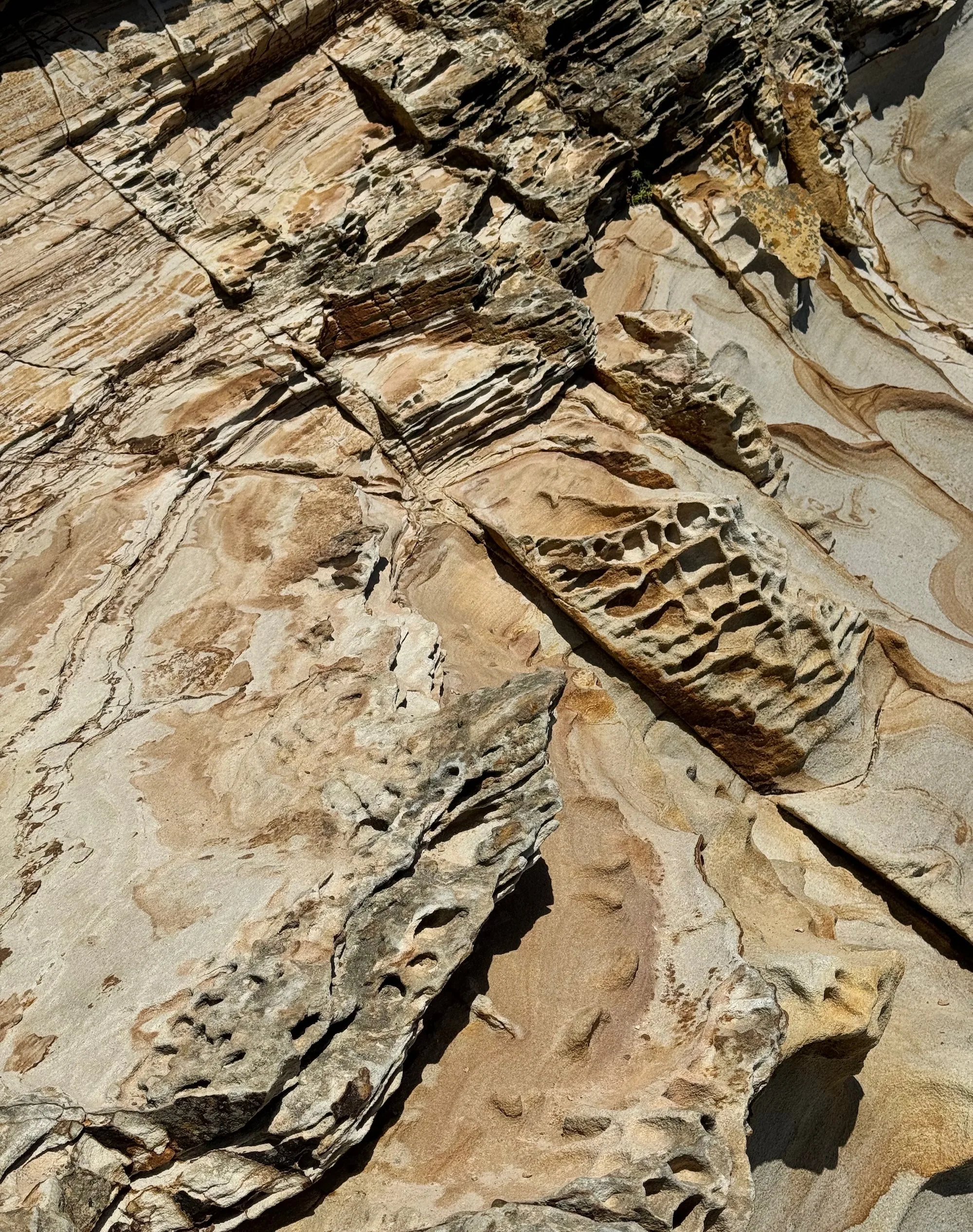 Colorful layered rock formations above the ocean
