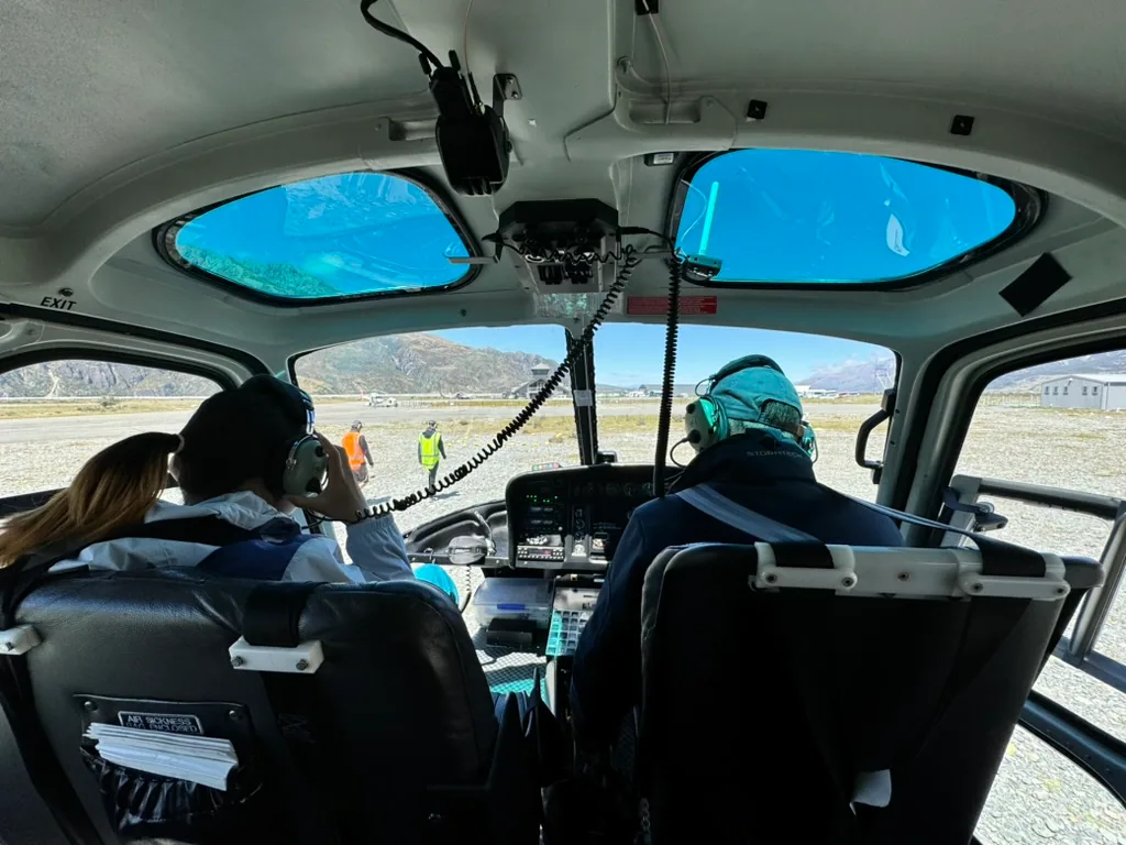 Passengers looking through the helicopter windshield