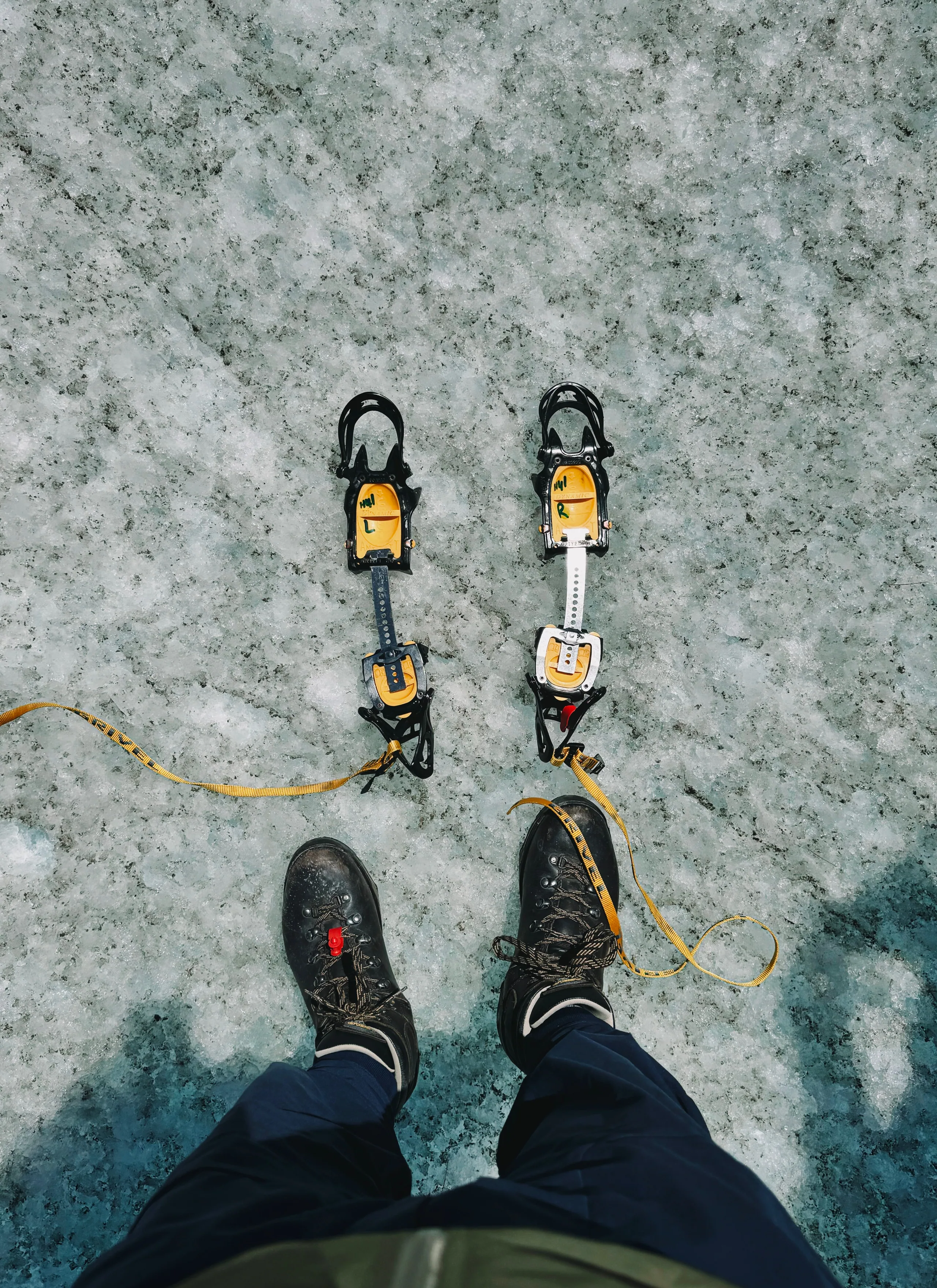 Hikers fitting crampons onto their boots on the glacier