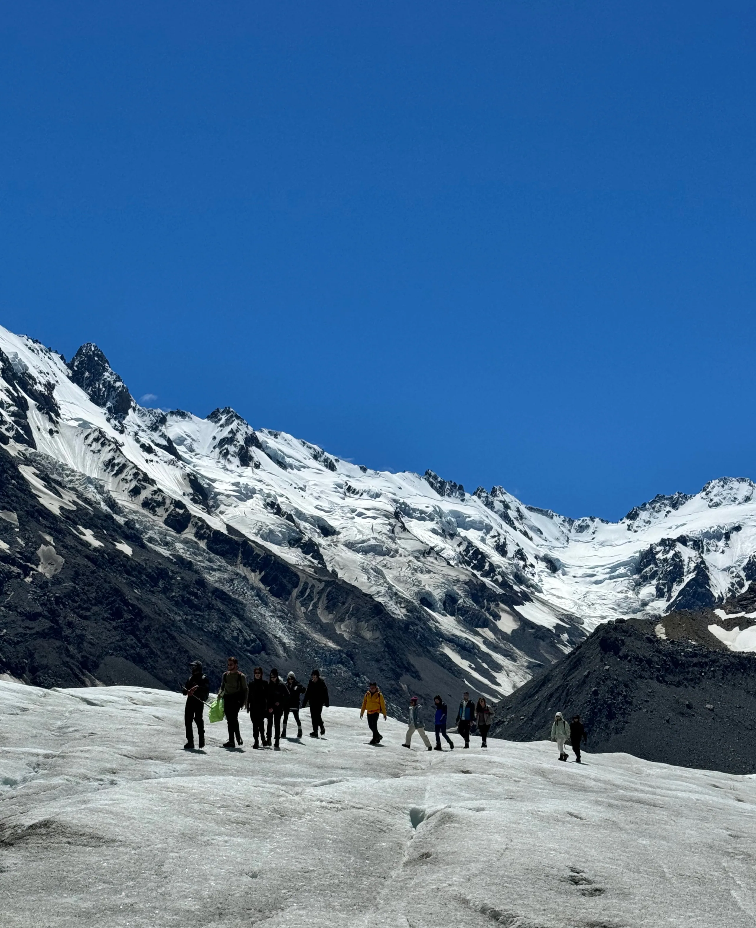 A close view of crampons and hiking boots on glacier ice