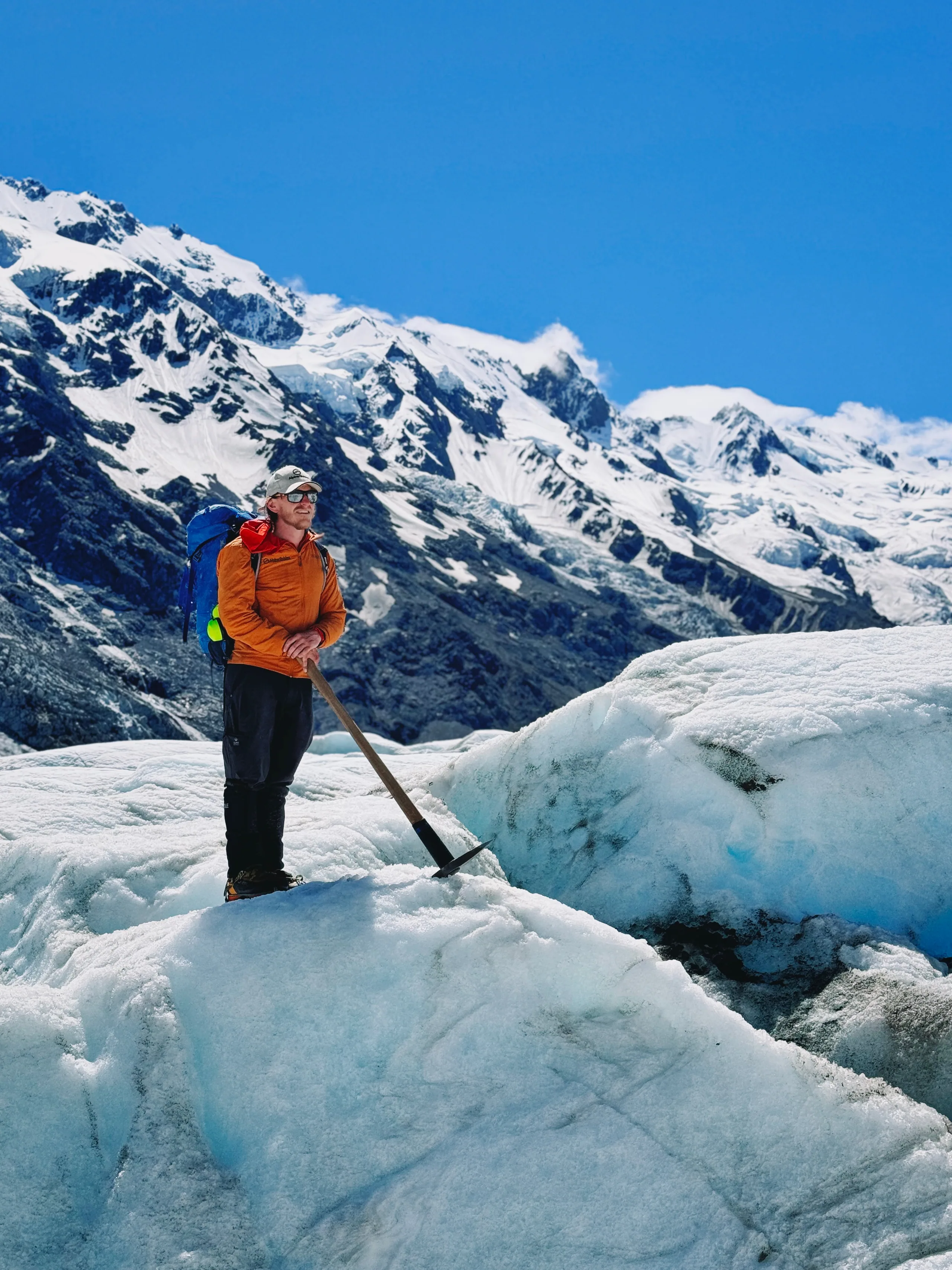 A glacier guide scouting the ice field ahead