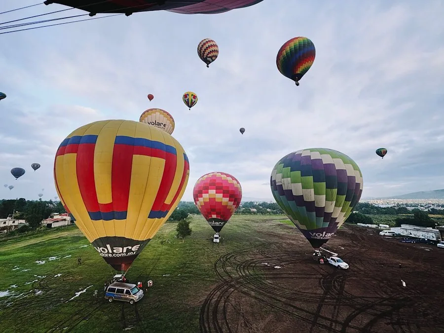 Colorful balloons rising over the launch field at Teotihuacan