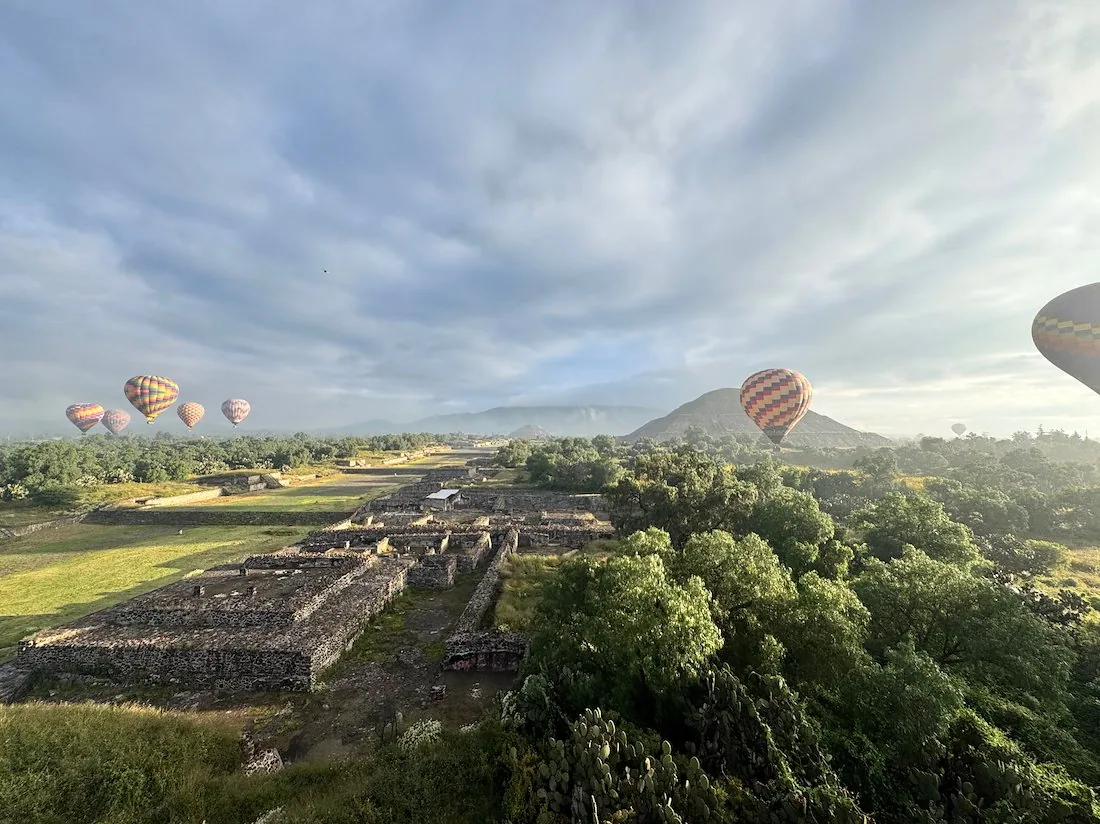 A pyramid and nearby balloons seen from the basket